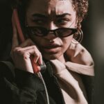 woman in black jacket wearing black sunglasses