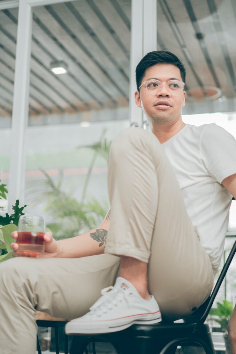 man in white crew neck t-shirt holding clear glass jar